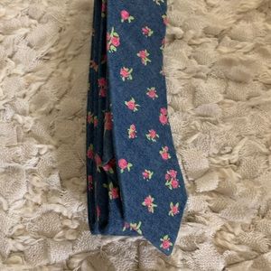 Blue Original Penguin Tie with pink flowers on it